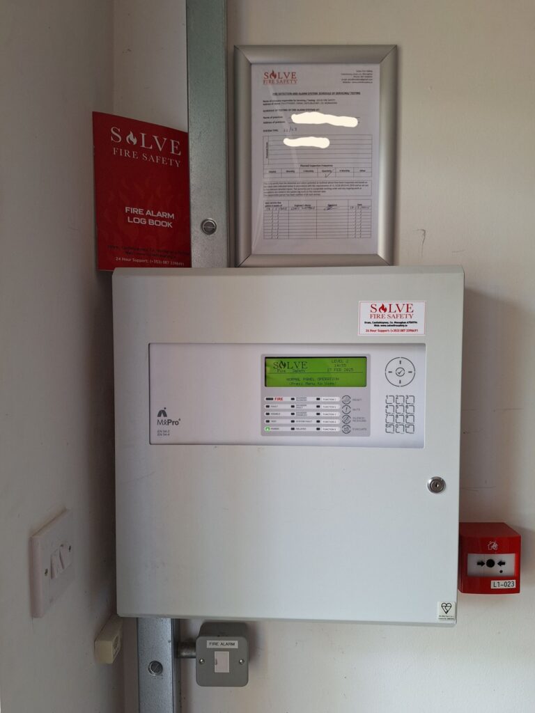 Commercial fire alarm control panel serviced by Solve Fire Safety in Dublin 17, demonstrating I.S. 3218 compliance logbook.