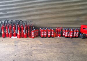 Certified engineer performing I.S. 291 fire extinguisher servicing in Ireland